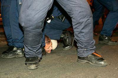 Hungarian protestor under Police heel
